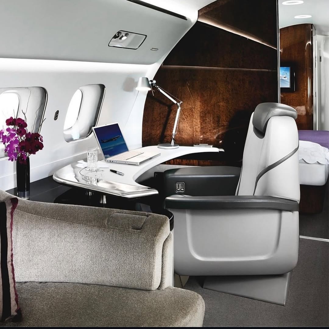 Luxury inside of a private jet, showcasing a desk workspace