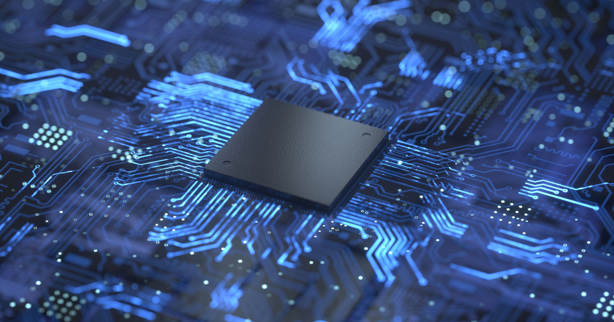 Close-up of a black microchip mounted on a blue circuit board with glowing electronic pathways.