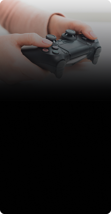 Person holding a black game controller for CPR common game console repair issues