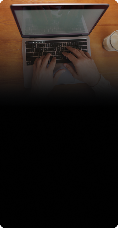 Person typing on a laptop next to a coffee for CPR common computer and laptop repair issues
