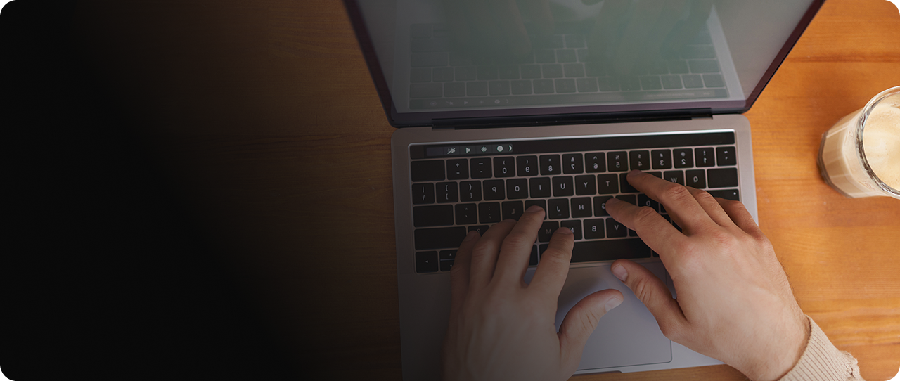Person typing on a laptop next to a coffee for CPR common computer and laptop repair issues