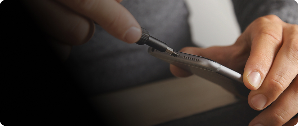 Close-up of a smartphone speaker being repaired