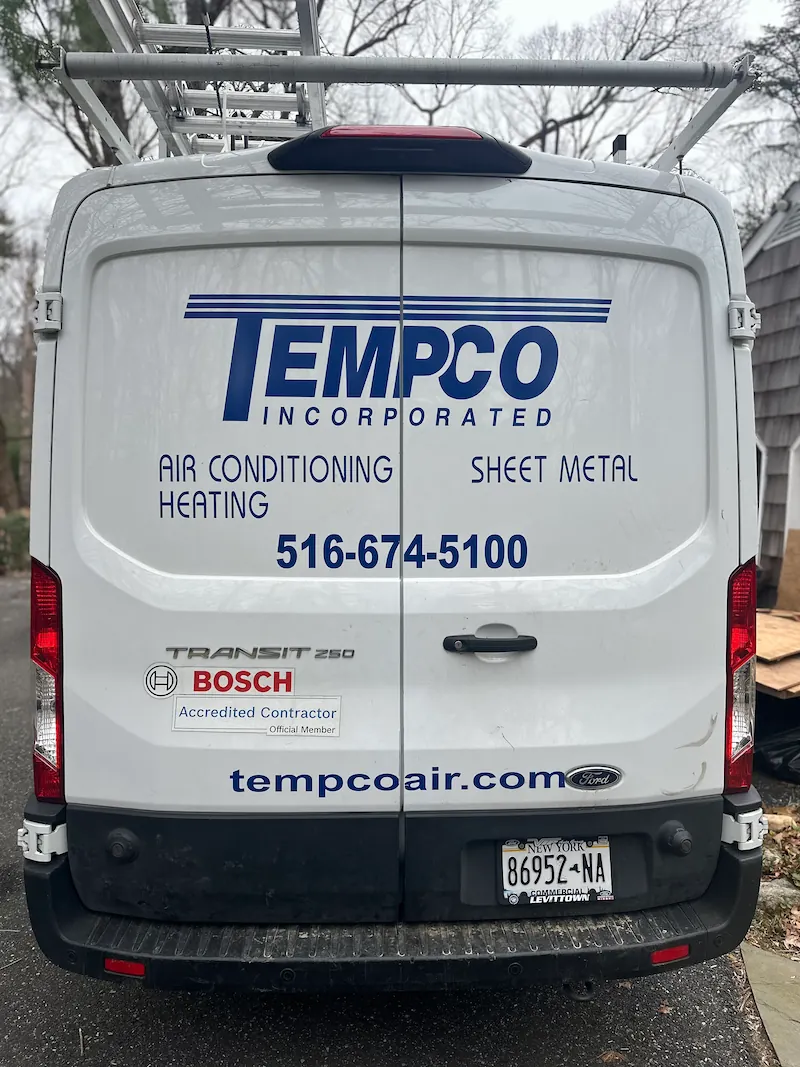 Rear view of a white Ford Transit 250 van with TEMPco Incorporated logo and services listed as air conditioning, heating, and sheet metal with contact number 516-674-5100 and website tempcoair.com.