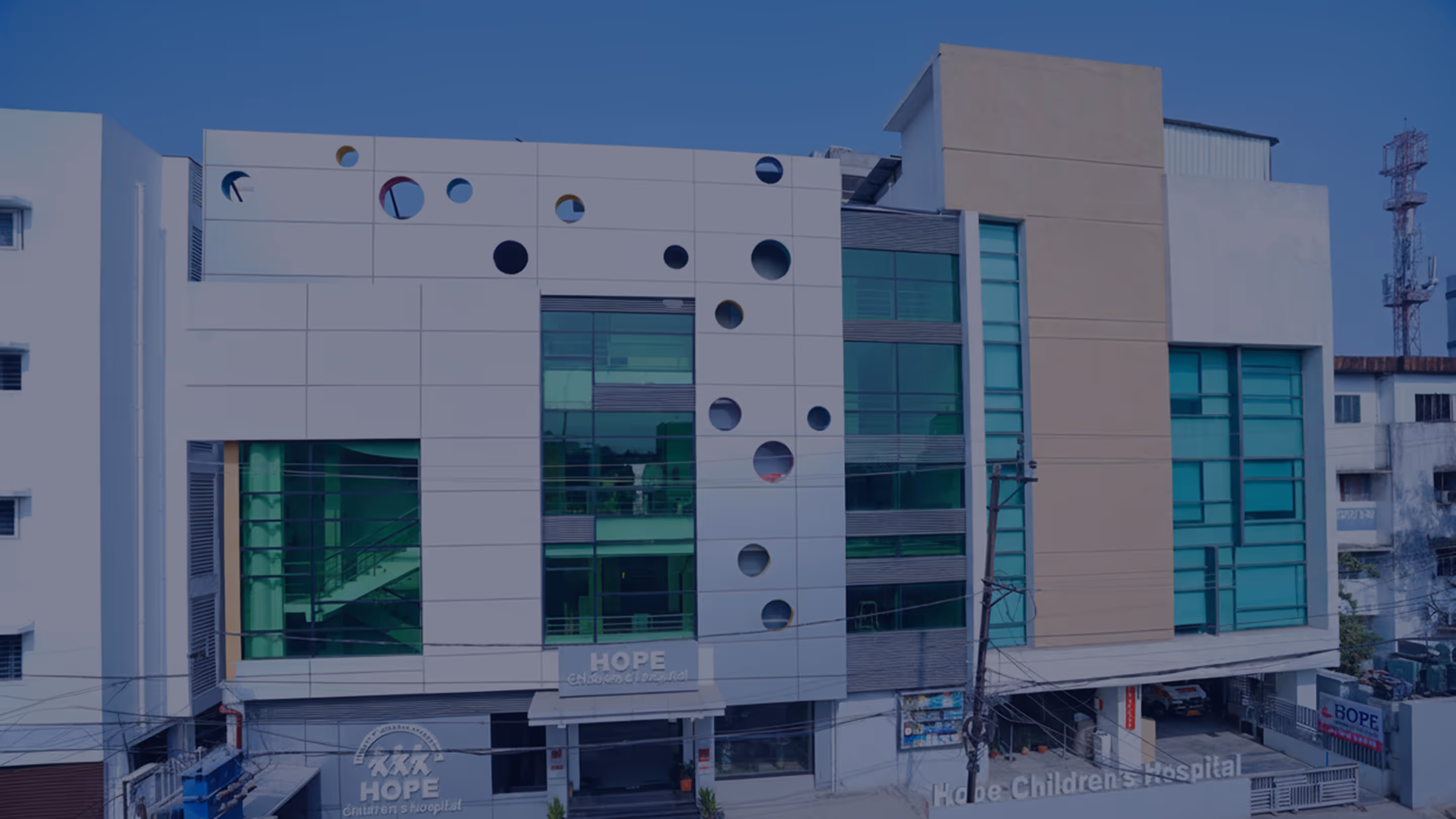 Modern multi-story Hope Children's Hospital building with unique circular window designs and large tinted glass panels.