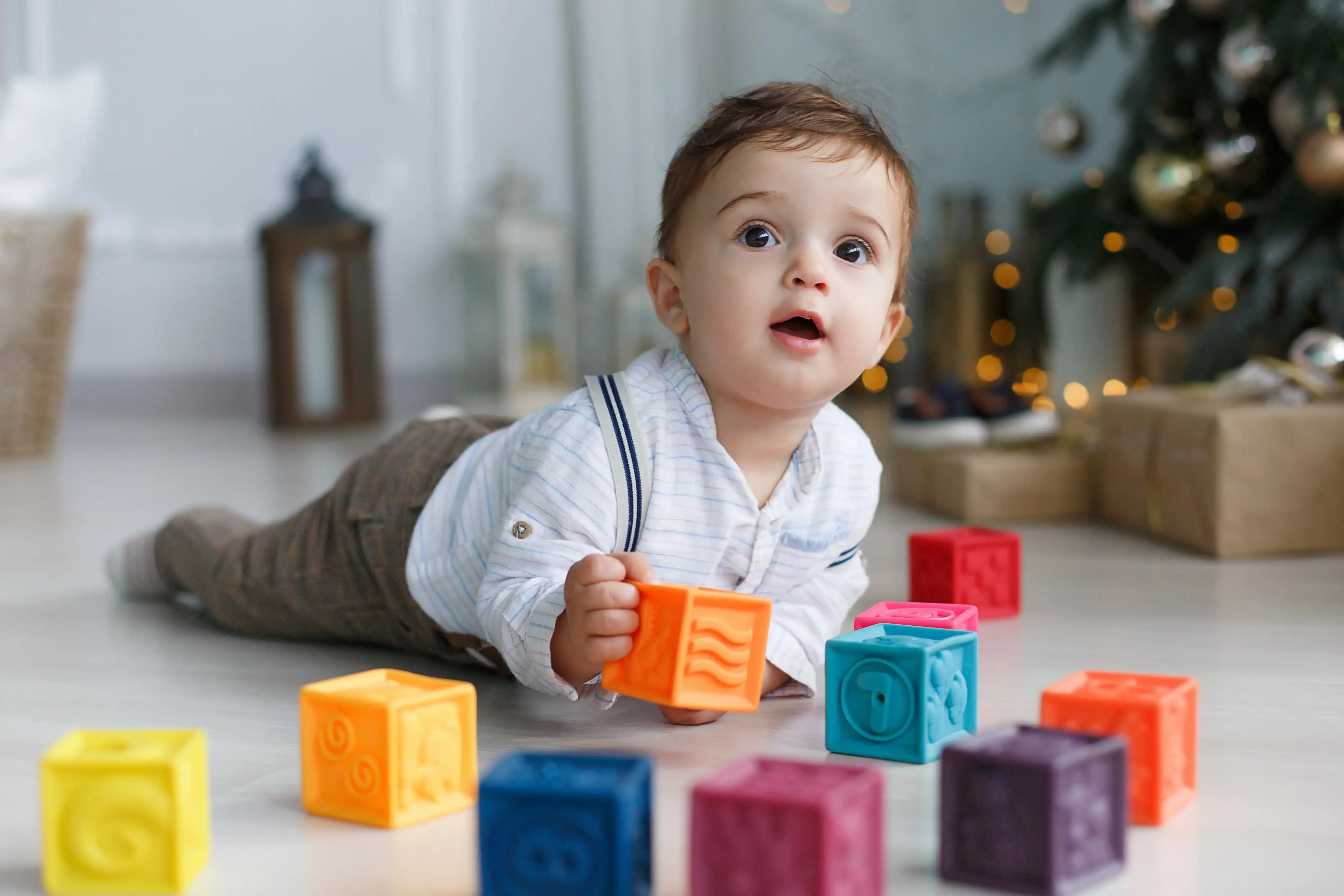 Cute baby with toys.