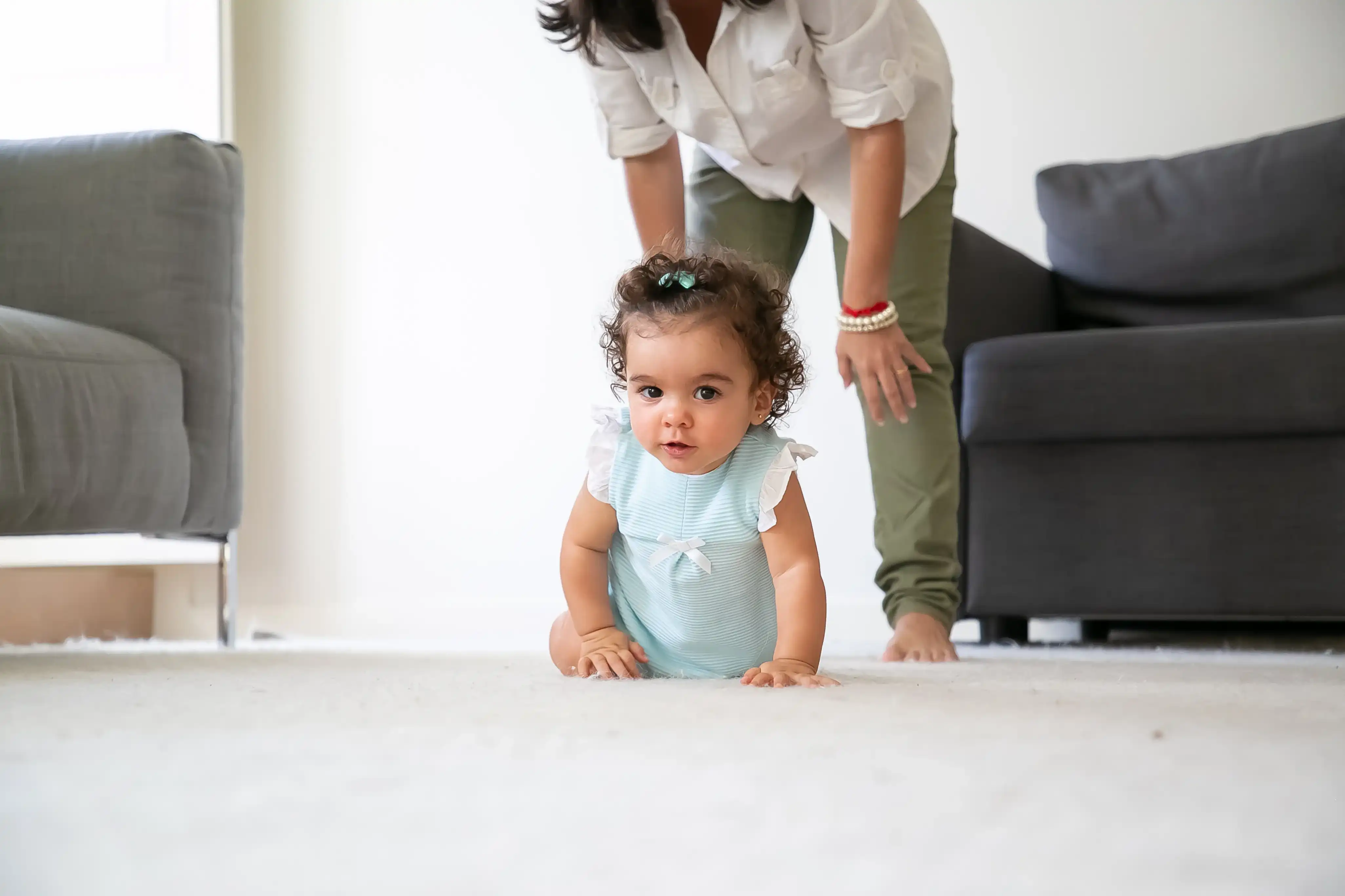 Cute-funny-baby-crawling-floor-home-mom-standing-little-child-parenthood-childhood-concept