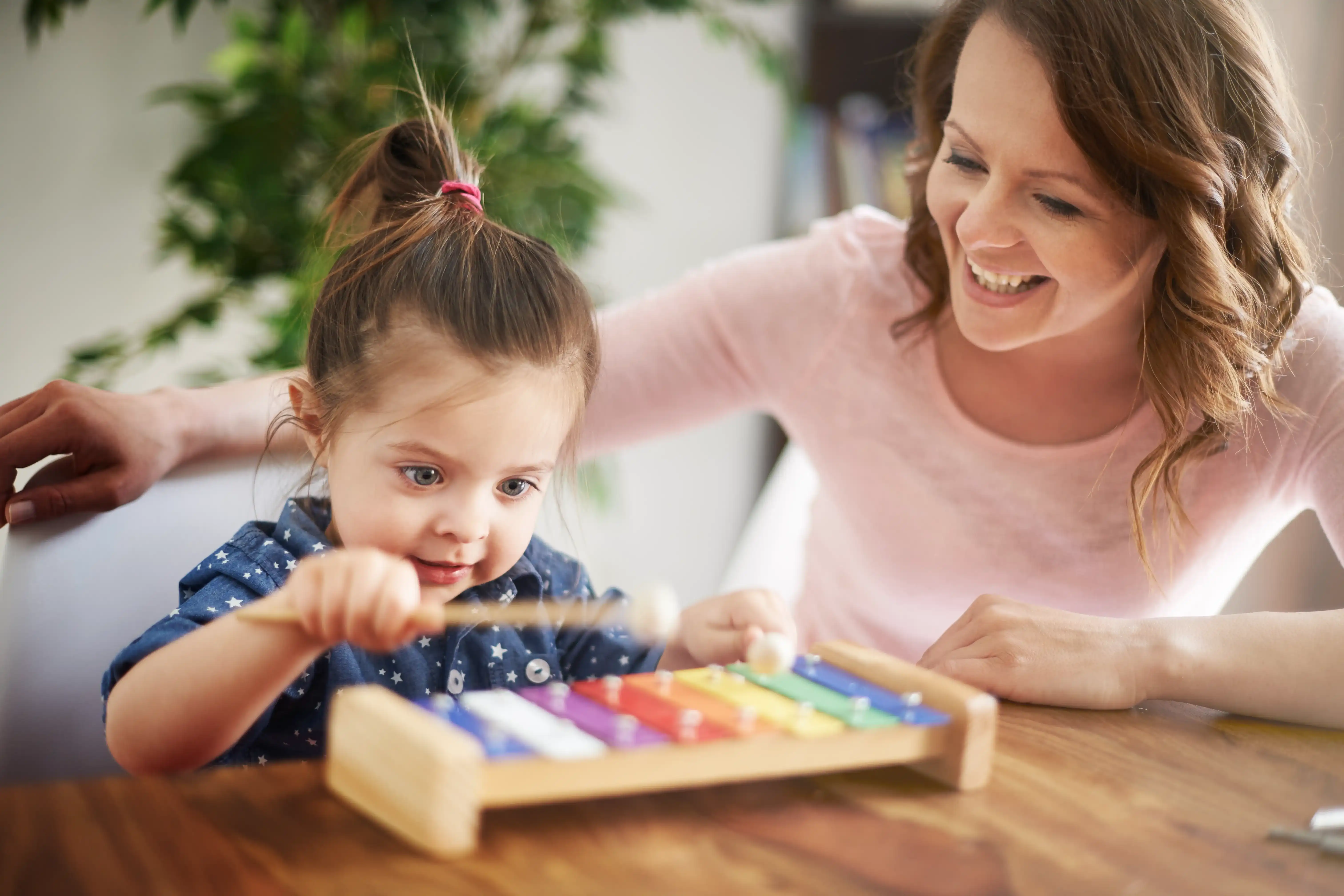 Speech-Language Pathologist - Clinical Fellow plays with the baby girl