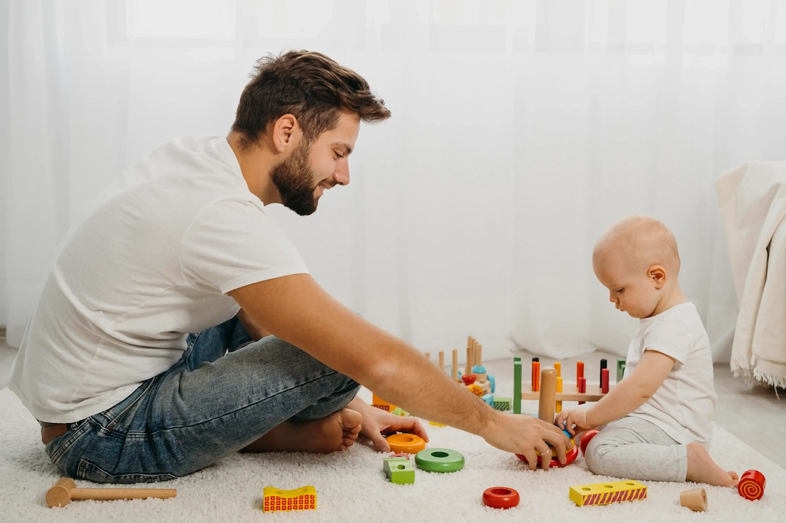 father teaching baby to play