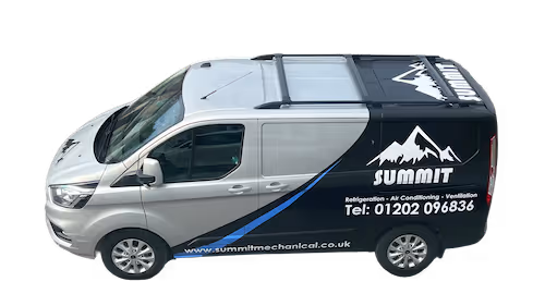 Gray and black Summit company van with mountain logo, contact number, and website on the side.