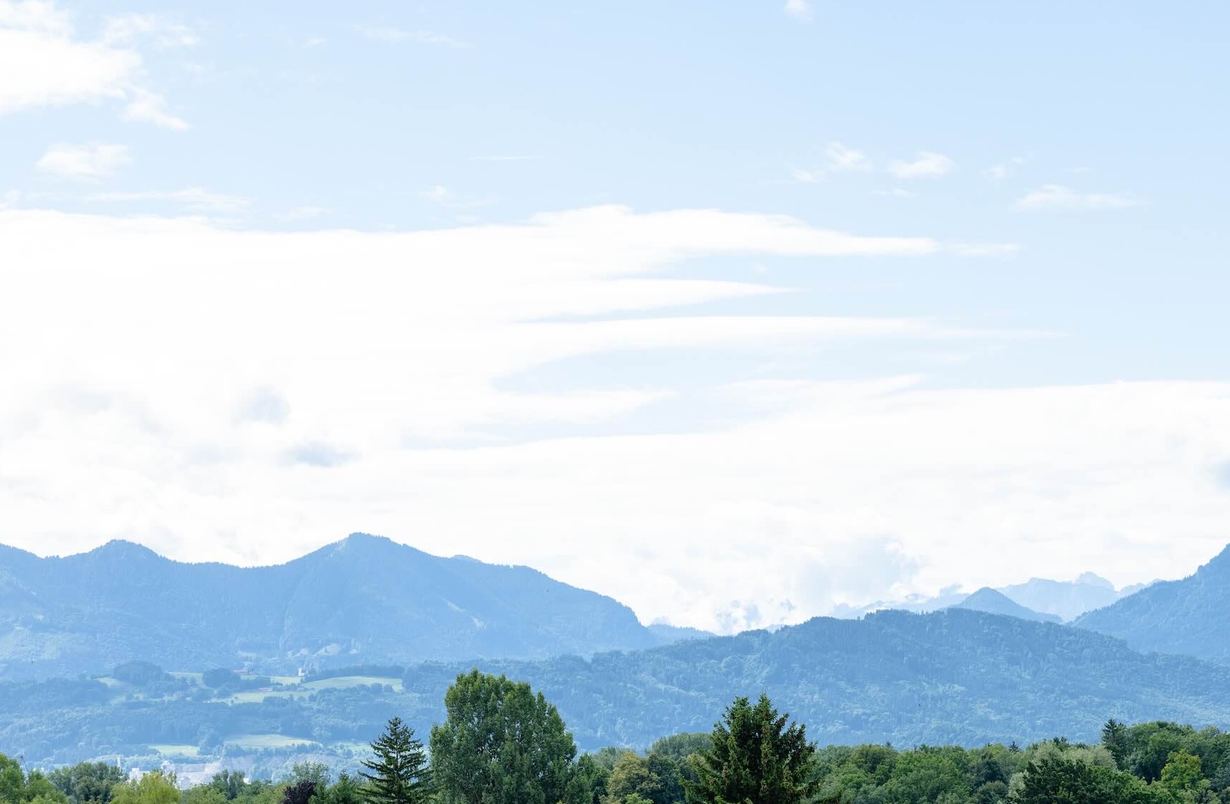 A wooden walkway leading to a building with a wooden deck.