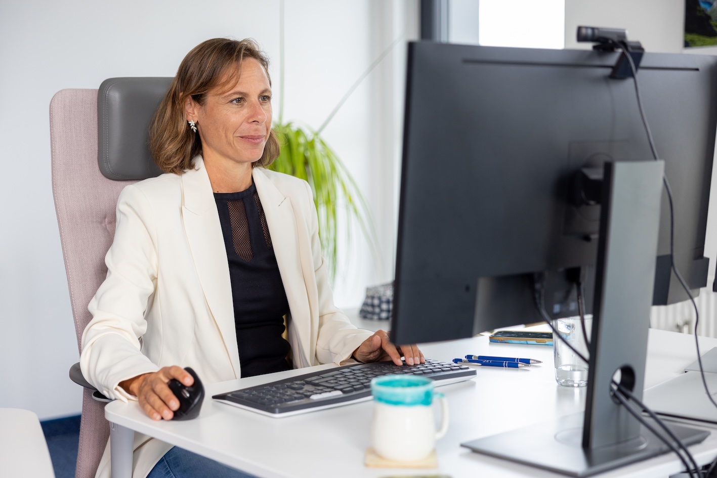 A wooden walkway leading to a building with a wooden deck.