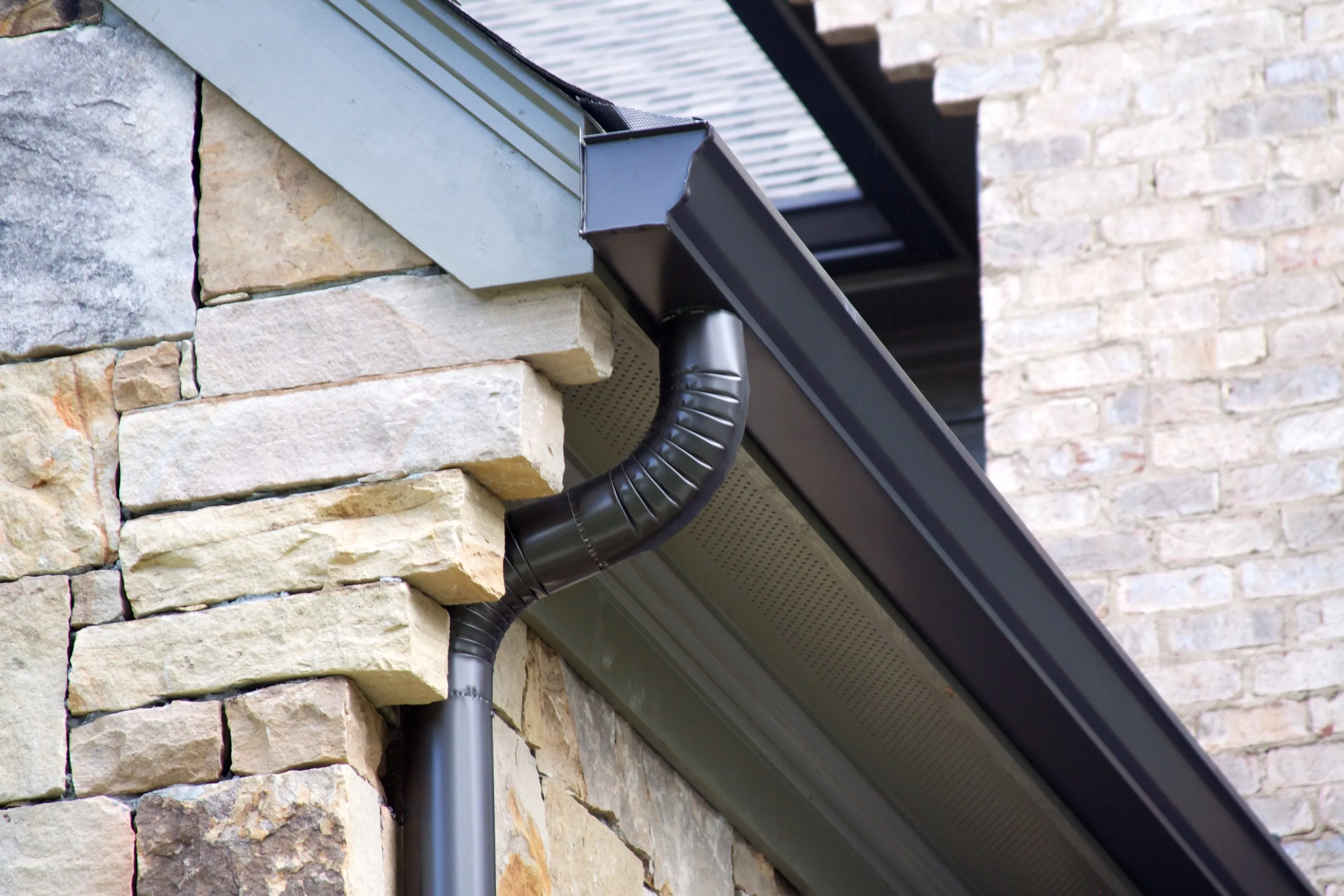 Black color gutter system on a house