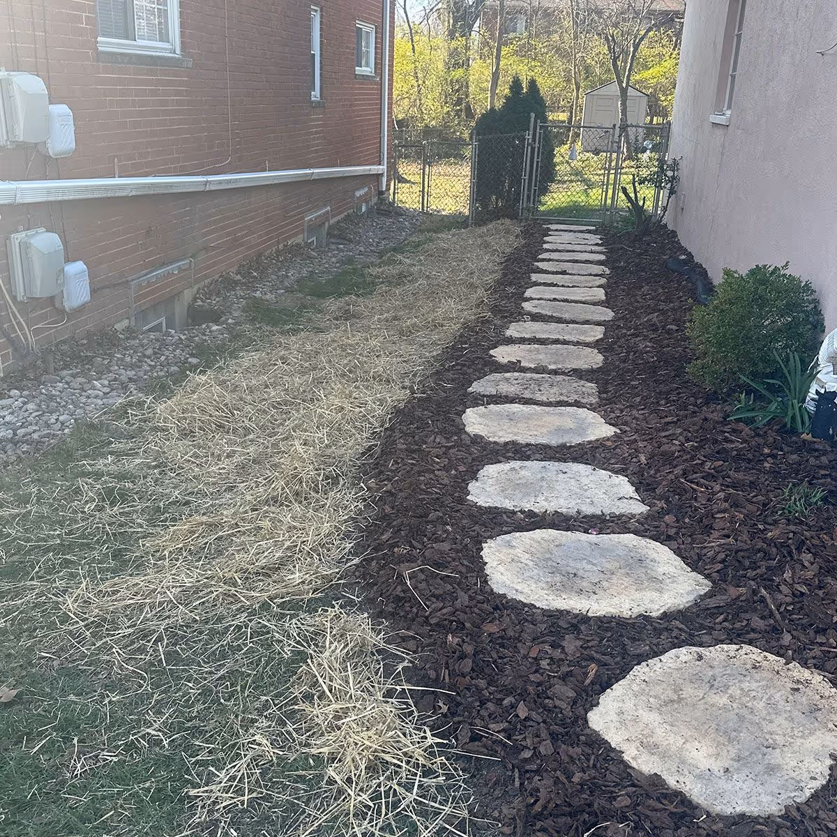 Garden bed refreshed with eco-friendly dyed mulch professionally applied