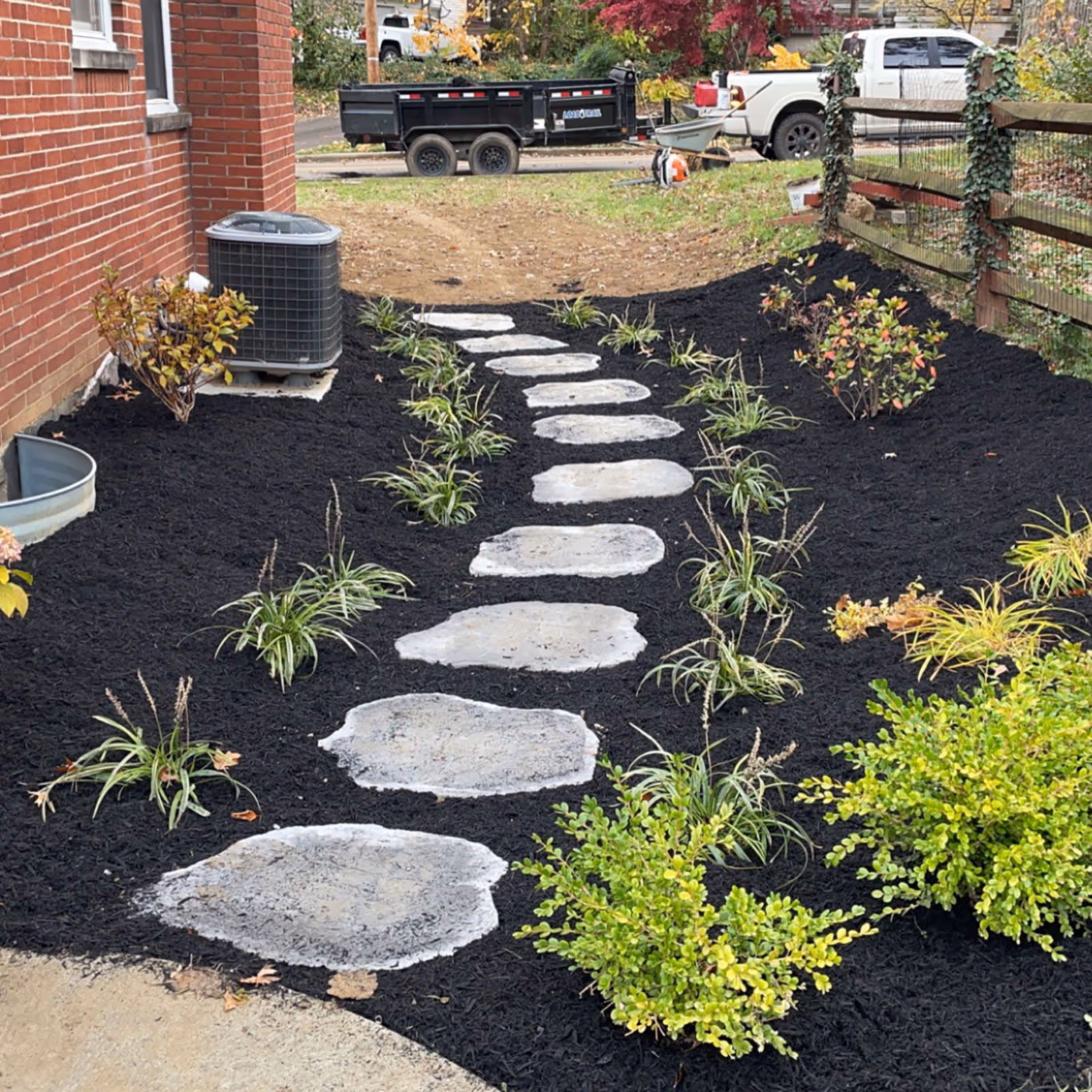 Elegant paver walkway with soldier course edging by Triscapes