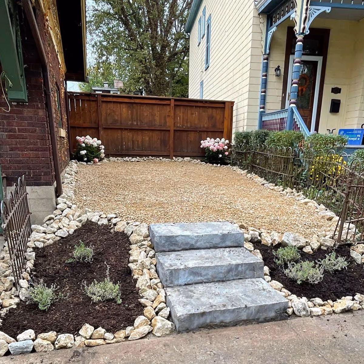 Triscapes landscape design near me featuring layered plant beds and stone accents