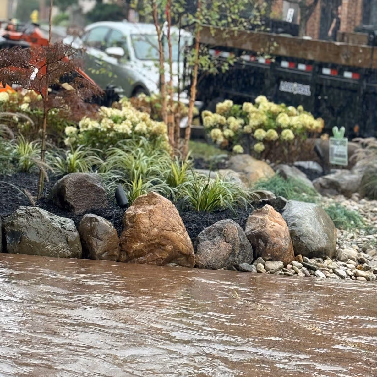 Expansive estate landscape with integrated lighting and water feature by Triscapes