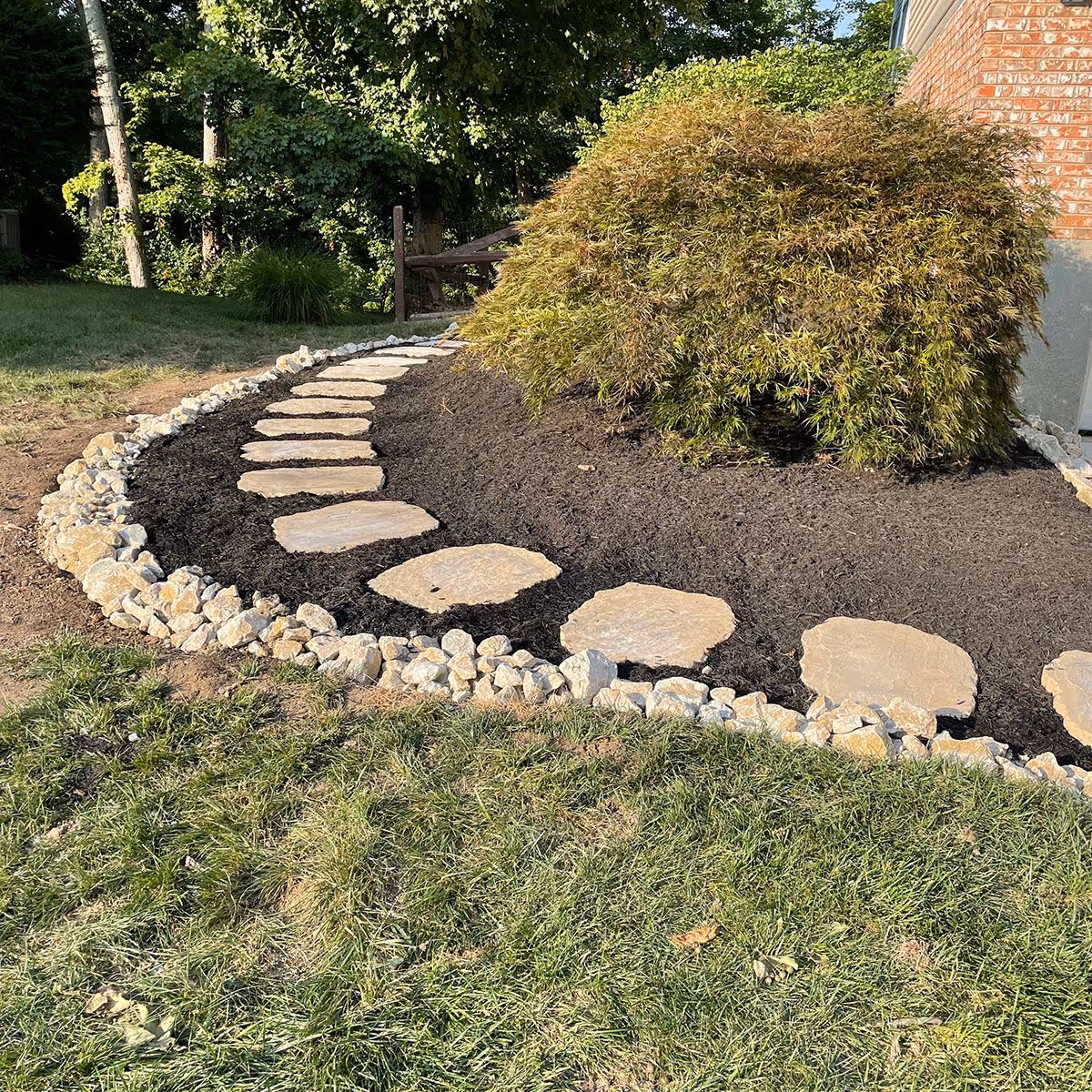 Custom plant bed design with privacy tree screening by Triscapes