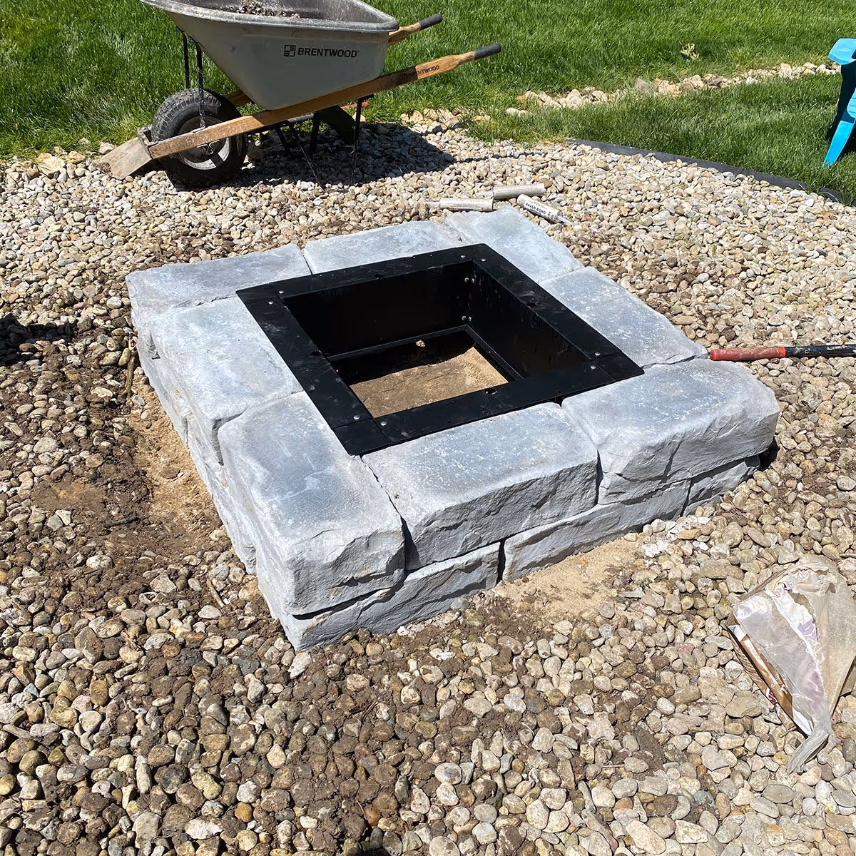 Custom stone fire pit with surrounding paver patio by Triscapes near me