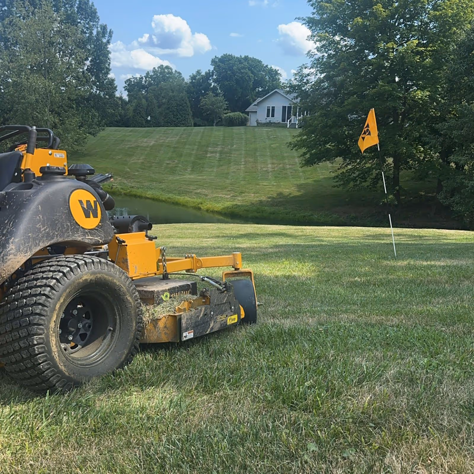 Commercial lawn care crew mowing a large property near me - Triscapes Greater Cincinnati