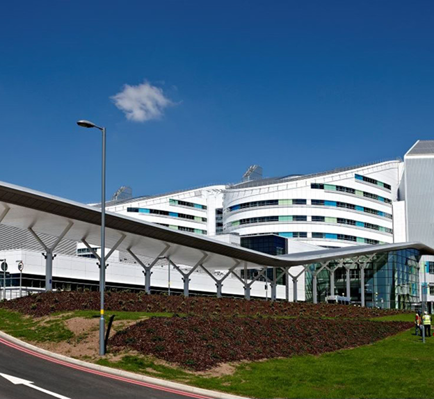 A modern NHS hospital building with large glass windows shown as a key visual element in a regional healthcare digital campaign.