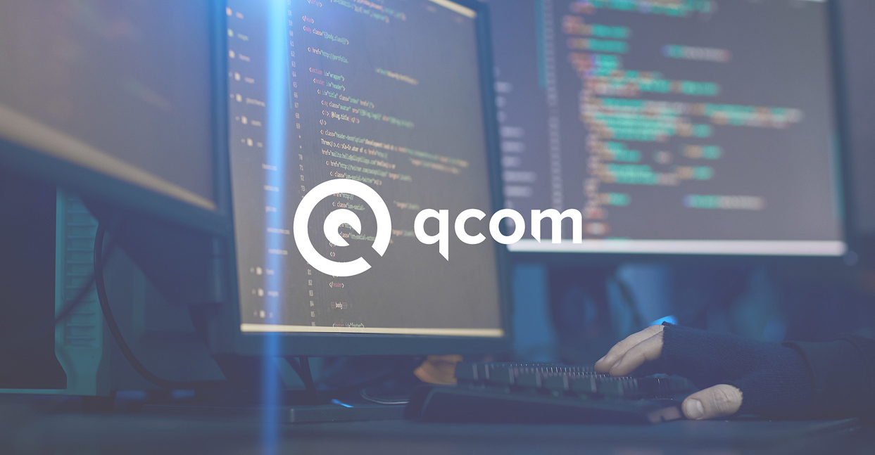 Qcom technology brand displayed on coding workstation monitors in a dark development setup as part of a marketing strategy for IT business.