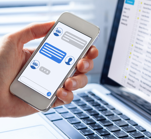 Close-up of a hand holding a smartphone with chat messages on screen, represented as part of 5rv Digital’s voip marketing.