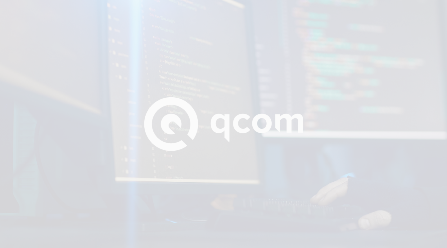 Qcom technology brand displayed on coding workstation monitors in a dark development setup as part of a marketing strategy for IT business.