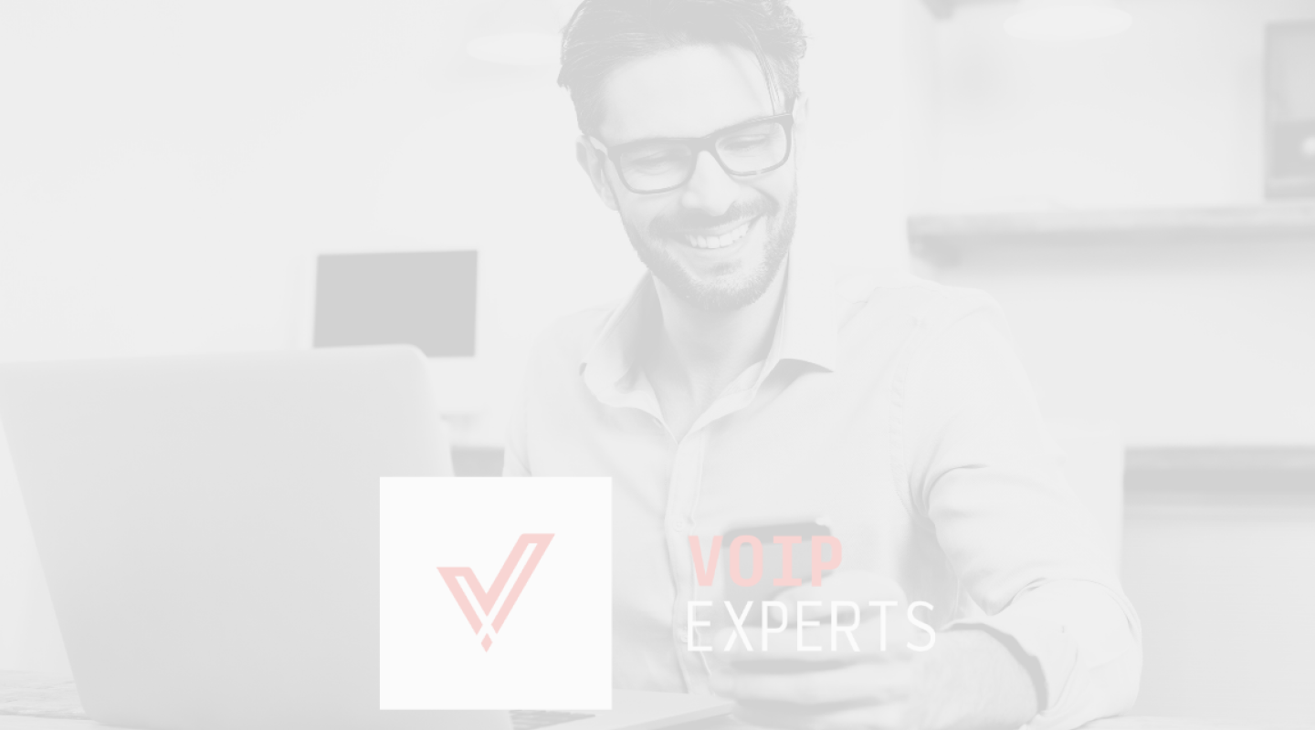 A man wearing glasses working on a laptop displaying the VOP Experts logo, created as part of 5rv Digital’s voip branding.