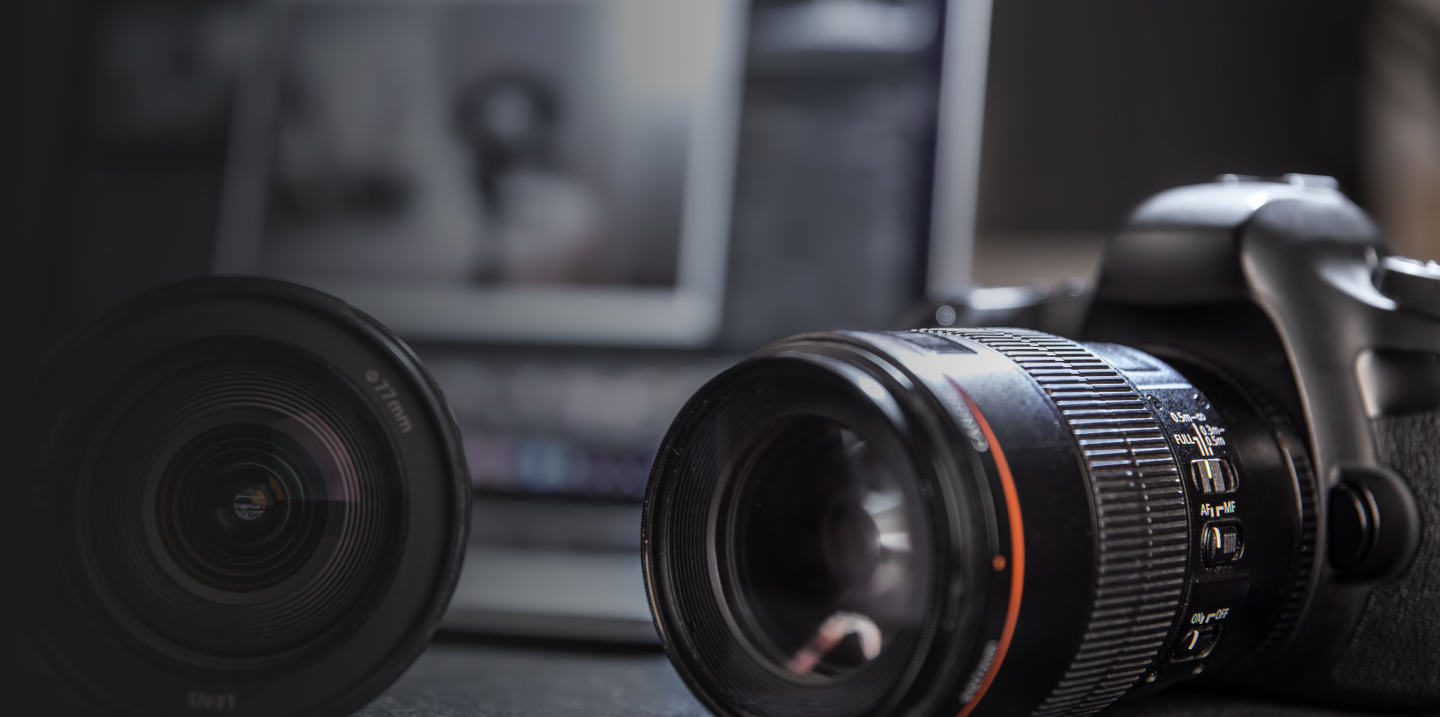 A camera and lens placed on a desk, showcasing the tools of a digital marketing agency based in Birmingham.