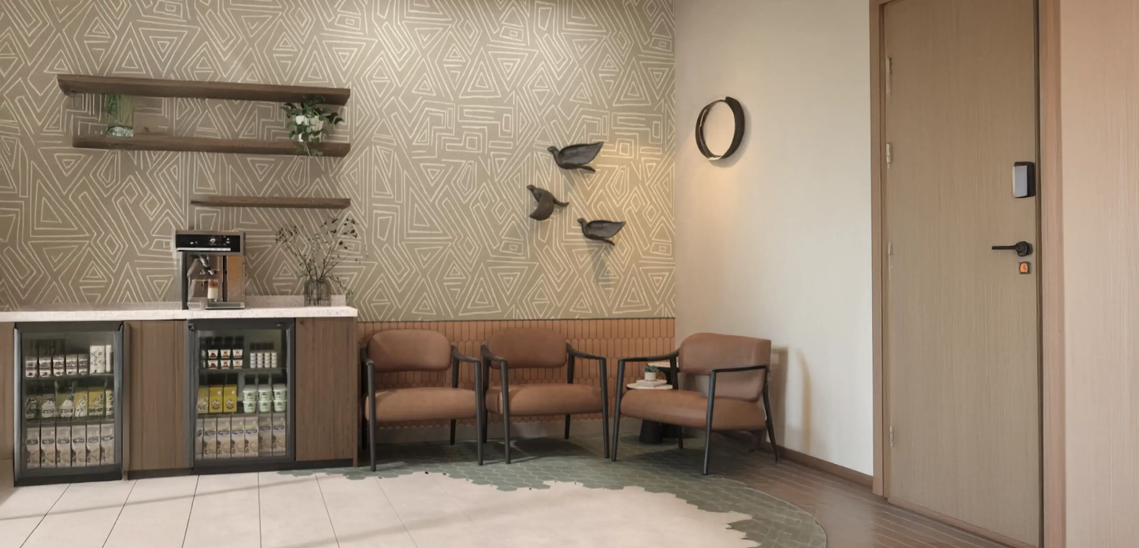 Two brown chairs and a side table in a waiting room with geometric wallpaper.