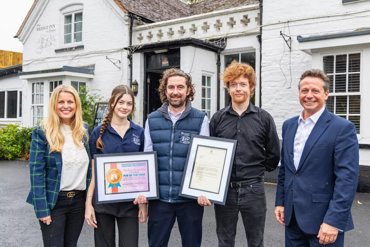 Owners of The Bridge Inn & Ferry outside the pub receiving pub of the year award.