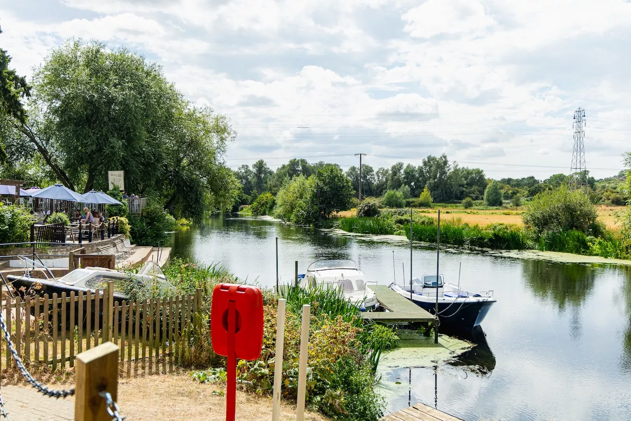 Riverside terrace at The Bridge Inn & Ferry, Offenham, overlooking the River Avon near Evesham with boats on the water