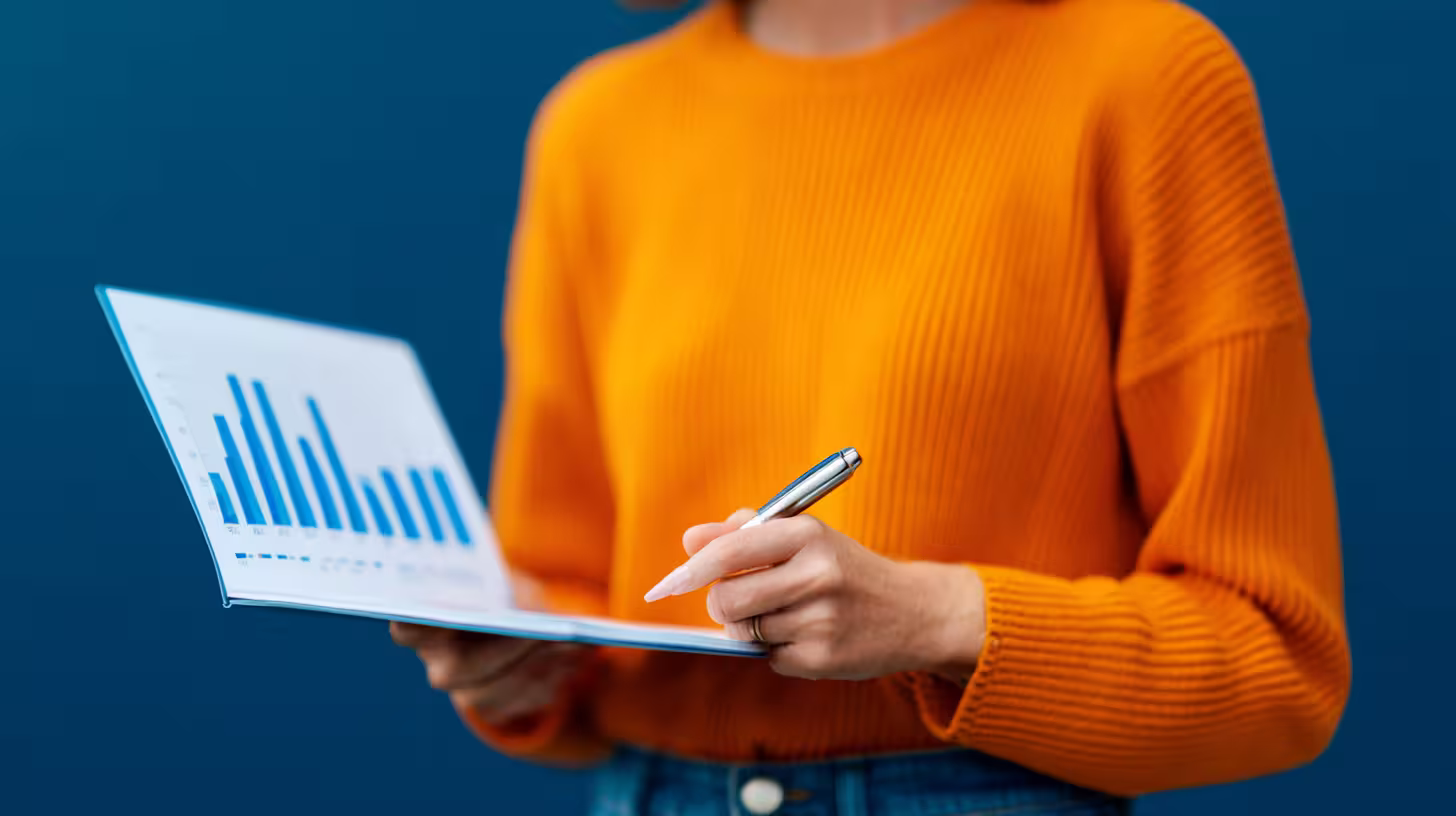 Person holding a chart report to analyze sales prospecting KPIs