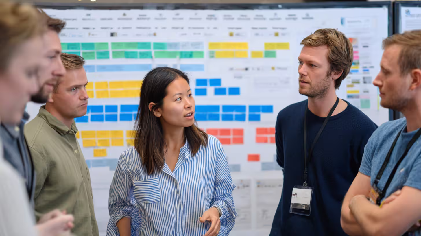 Sales team gathered in front of a planning board to prospect with AI