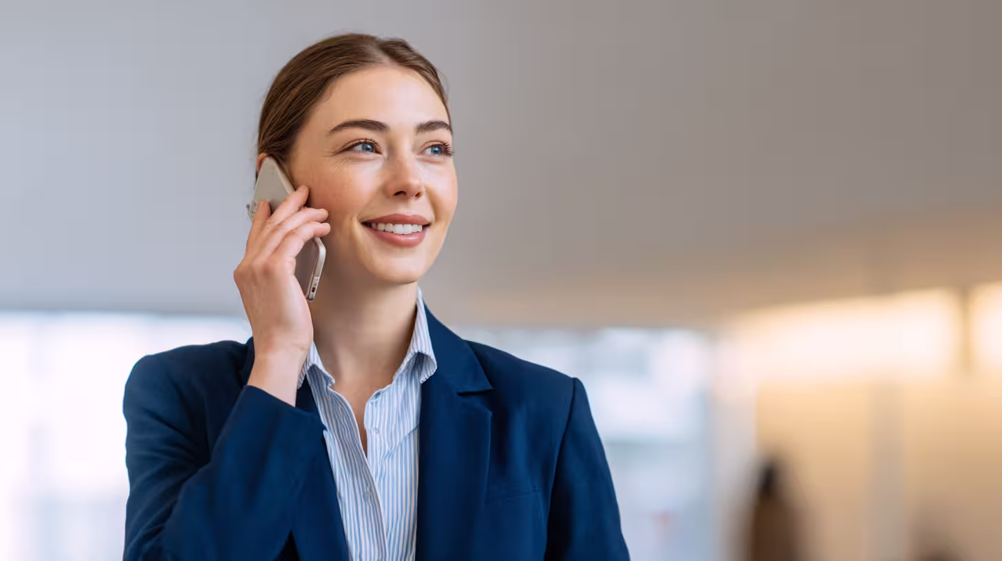 Smiling saleswoman on the phone with a prospect, prospecting effectively in B2B