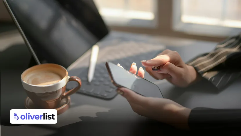 Saleswoman checking her smartphone next to a tablet to organize her prospecting schedule