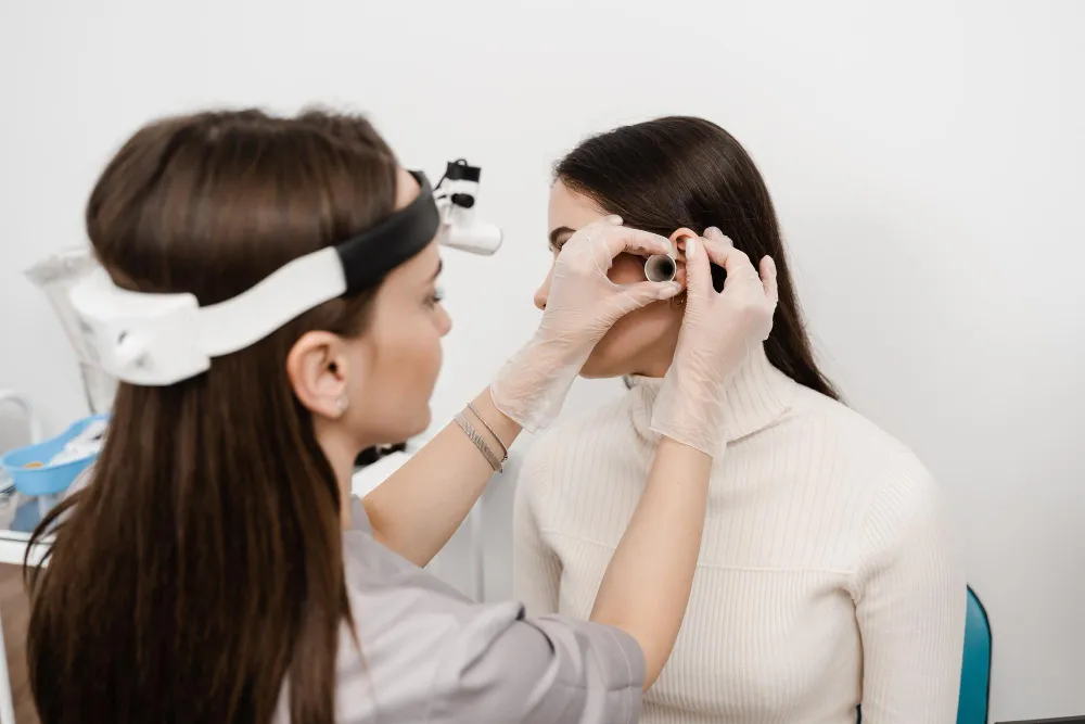 Optometrist performing ear examination with medical equipment
