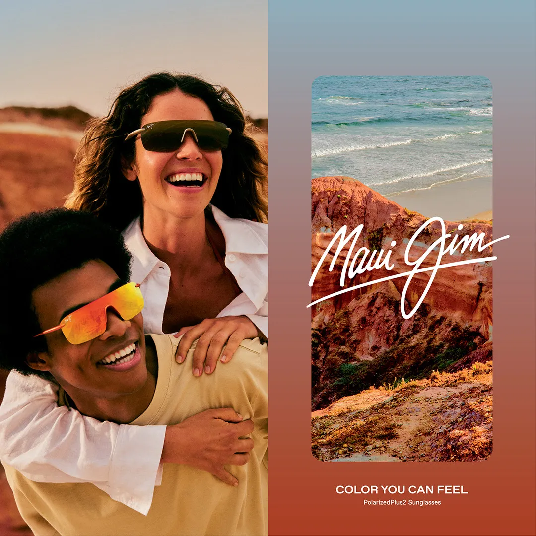 Two people laughing and wearing colorful Maui Jim sunglasses by the beach