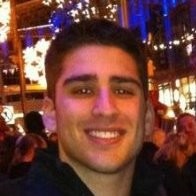 headshot of Alex smiling at night