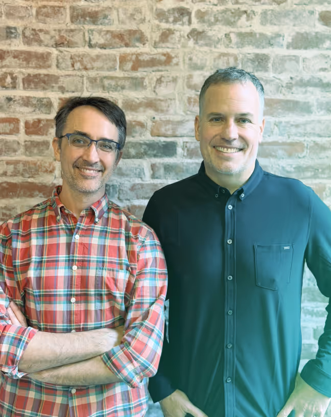 headshot of two men smiling