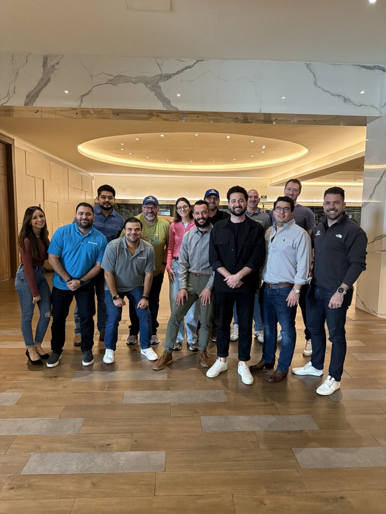 About a dozen teammates together in a hotel lobby