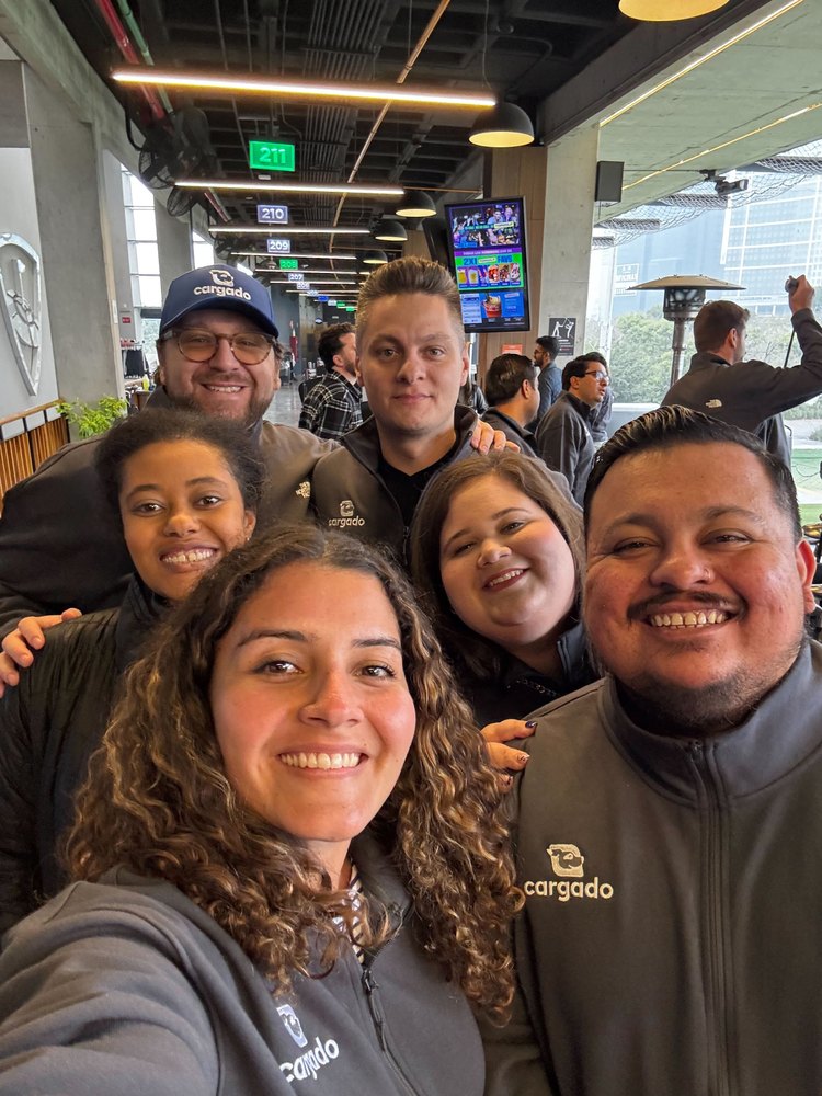 Six teammates in Cargado fleeces taking a selfie