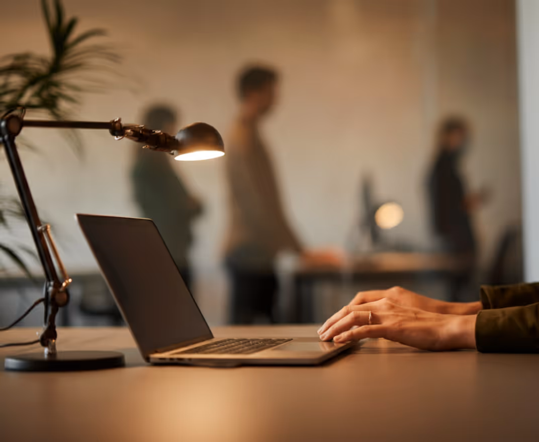 Mans hands typing on a laptop