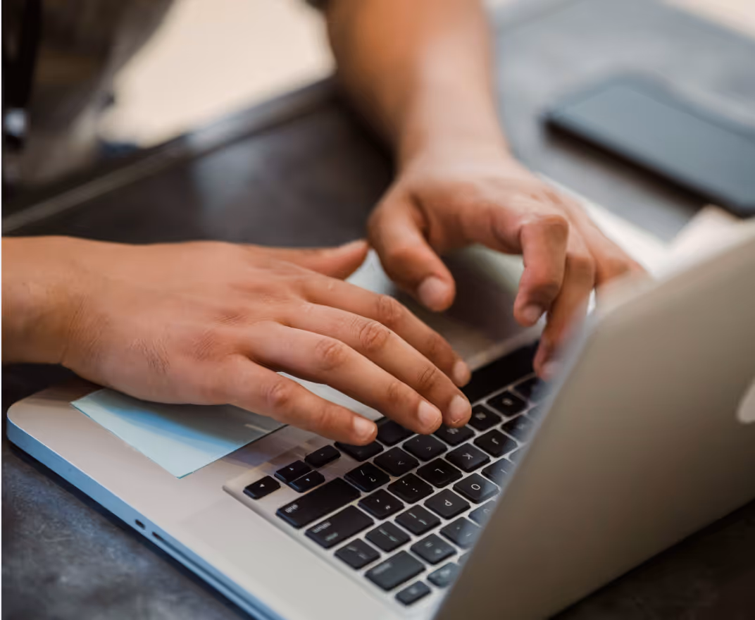 Man typing on laptop