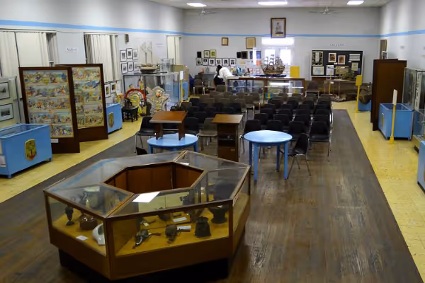 a room filled with furniture and a table in a museum