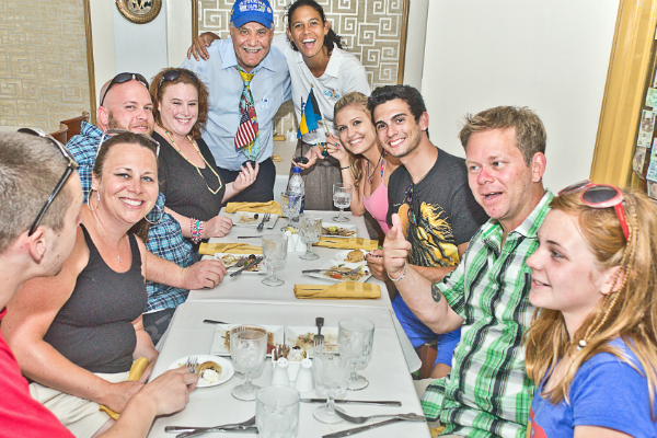a group of people sitting at a table posing for the camera