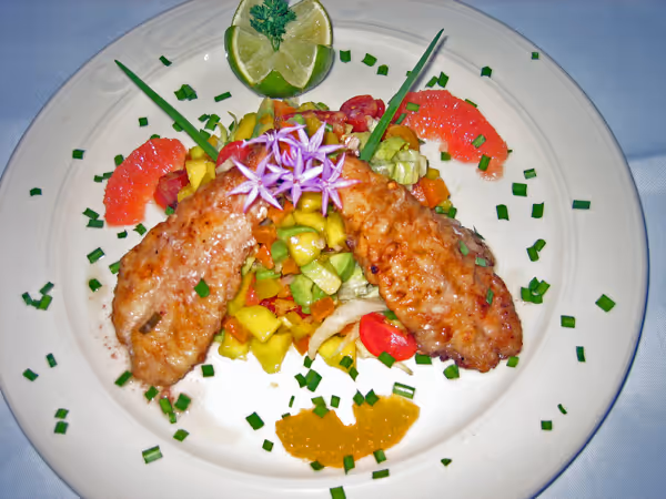 a white plate topped with meat and vegetables