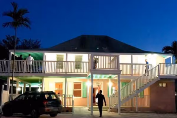 a group of people walking in front of a building