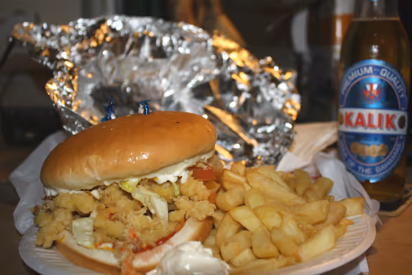 a close up of a bottle next to fries