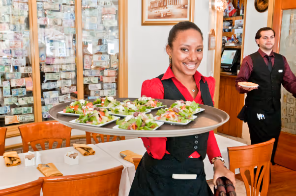 people standing at a table with a plate of food